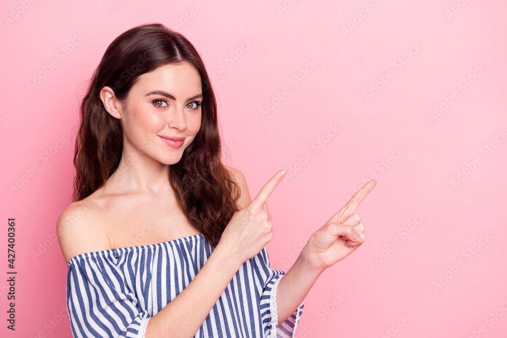 Photo of nice optimistic brunette lady point empty space wear blue dress isolated on pastel pink color background Photo of nice optimistic brunette lady point empty space wear blue dress isolated on pastel pink color background