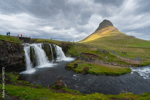 Icelandic waterfall with Kirkjufell mountain in the background.