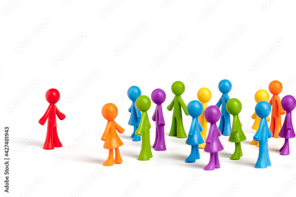 . Toy people Isolated on white background. The red man stands apart from the group. Asociality, sociopathy. Rejected by society, lonely. Development of leadership and social qualities.