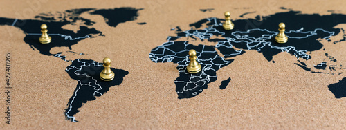 concept of geopolitics or worldwide economy. chess figures placed on map banner photo