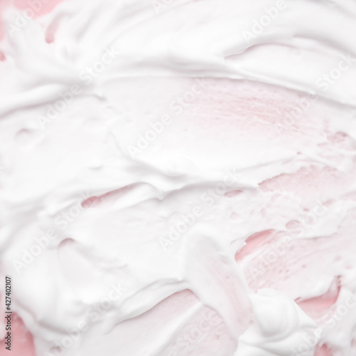 White cosmetic foam texture on pink on pink background. Cosmetic mousse, cleanser, shaving foam, shampoo. Foamy skin care product, skincare, male hygiene concept, copy space