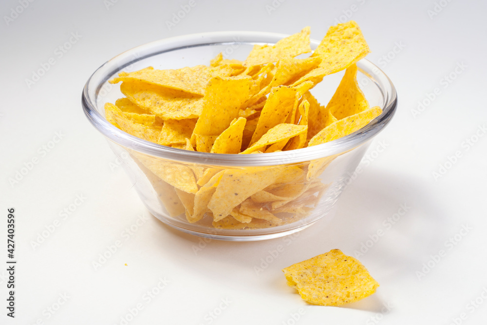 Nachos chips in glass bowl on isolated background
