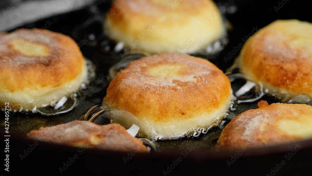 frying cheese pancakes from cottage cheese