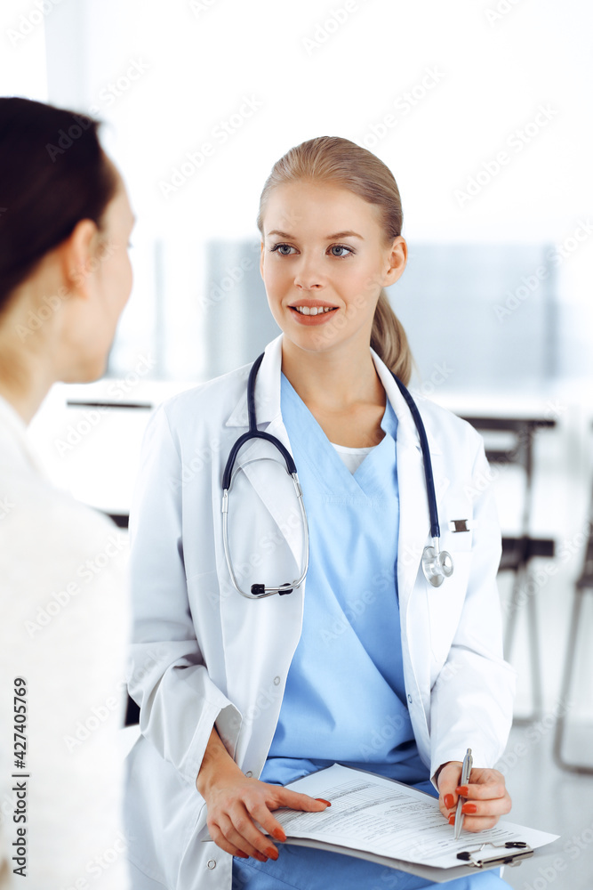 Woman - doctor consults her female patient while using clipboard and medication history record. Medicine concept Woman - doctor consults her female patient while using clipboard and medication history record. Medicine concept