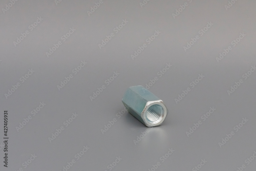 Extended galvanized coupling nut on gray gradient background. Extended galvanized coupling nut on gray gradient background.
