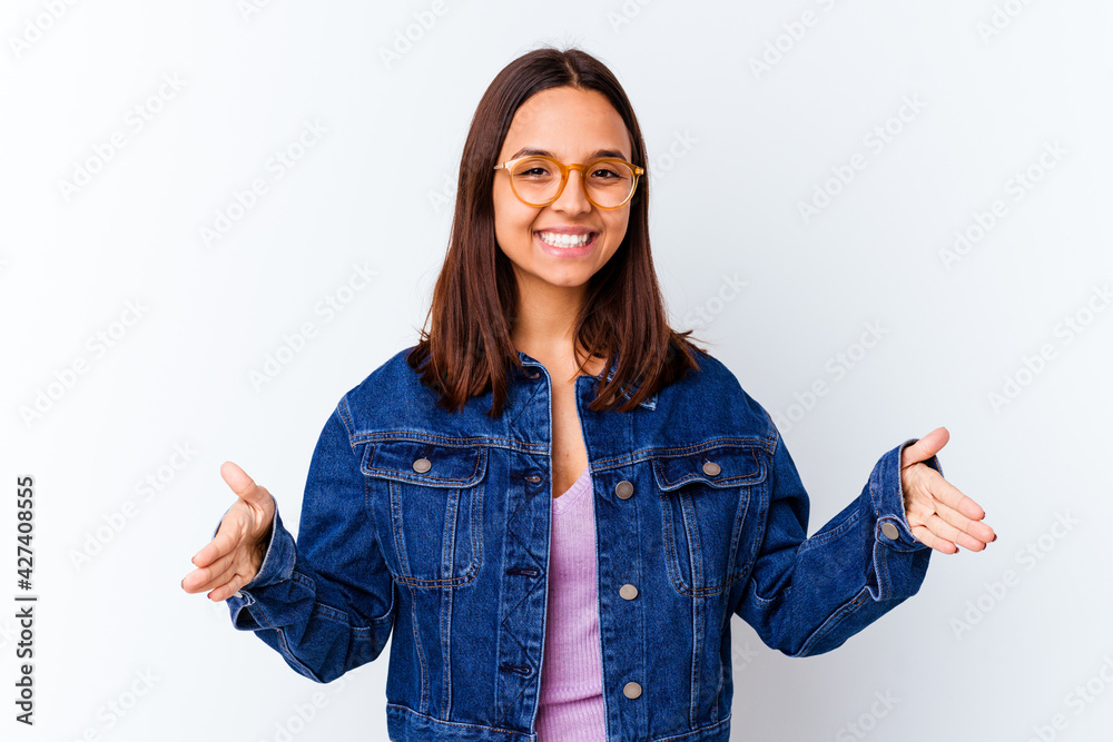 Young mixed race woman isolated holding something with both hands, product presentation. Young mixed race woman isolated holding something with both hands, product presentation.