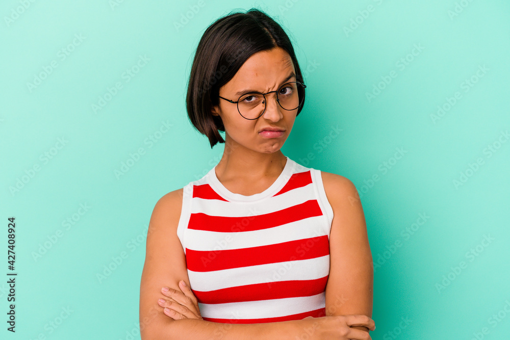Young mixed race woman isolated on blue background unhappy looking in camera with sarcastic expression. Young mixed race woman isolated on blue background unhappy looking in camera with sarcastic expression.
