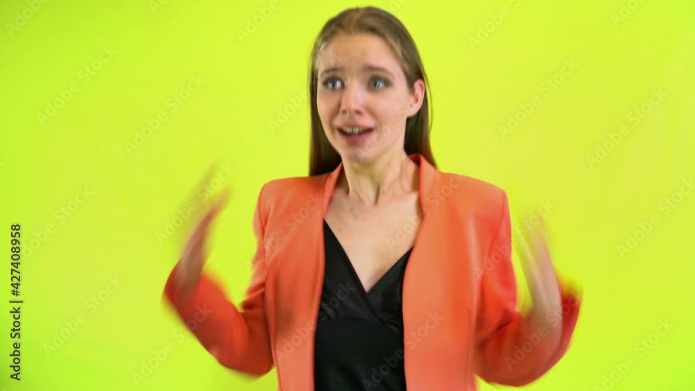 Scared woman screaming horror in space studio over yellow Scared woman screaming horror in space studio over yellow