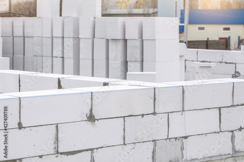 Construction of Aerated Concrete. Unfinished house wall made from white aerated autoclaved concrete blocks