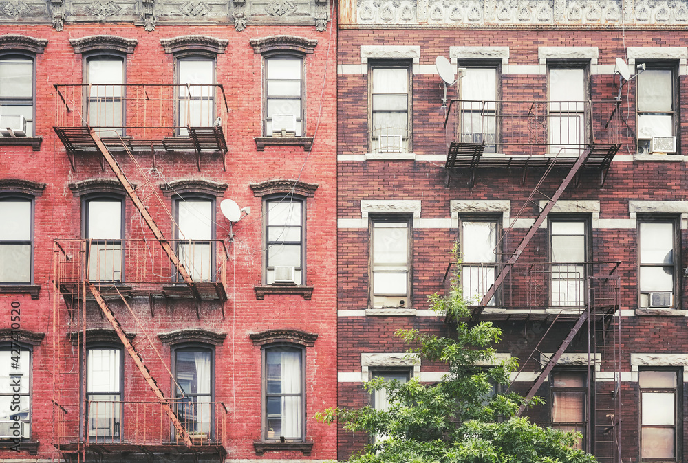 Obraz premium Old buildings with iron fire escapes, color toned picture, New York City, USA.
