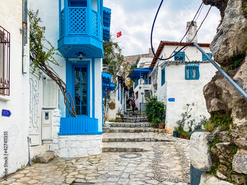 Beautiful Streets of old Marmaris. Narrow streets with stairs among the houses with white brick, green plants and flowers in the old town of resort of in Turkey