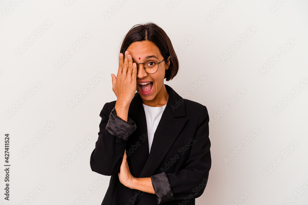 Young business Indian woman isolated on white background having fun covering half of face with palm. Young business Indian woman isolated on white background having fun covering half of face with palm.
