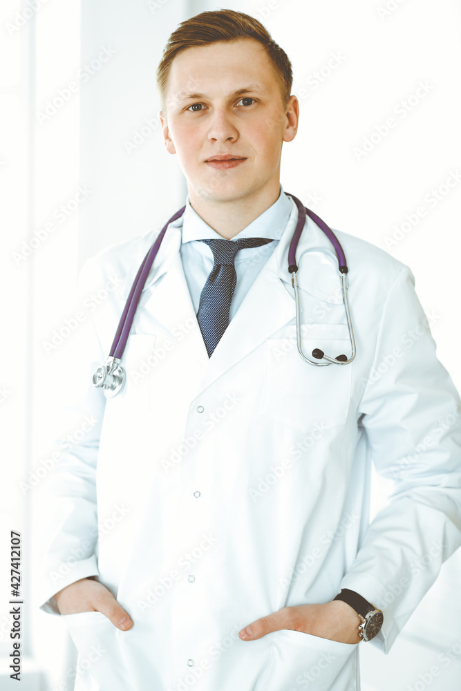 Doctor man standing straight in medical office or clinic. Medicine concept Doctor man standing straight in medical office or clinic. Medicine concept