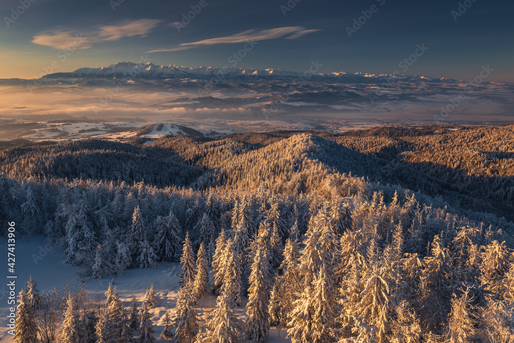 Winter morning in Gorce on the tower on the top of Luban. A beautiful, romantic atmosphere with a view of the Pieniny Mountains, the Beskids and the Tatra Mountains.

