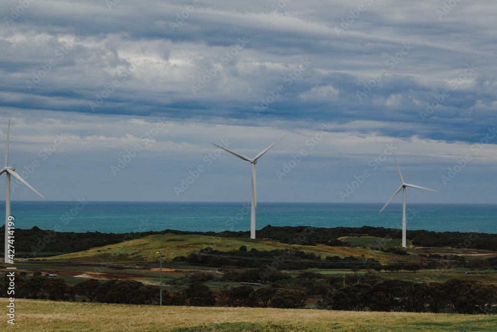 Australian landscape featuring row of wind turbines along the coast line at Cape Nelson, Portland Victoria Australia Australian landscape featuring row of wind turbines along the coast line at Cape Nelson, Portland Victoria Australia