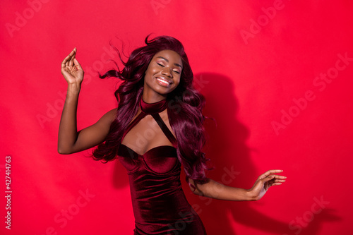 Photo of young attractive black girl happy positive smile stunning air hair isolated over red color background