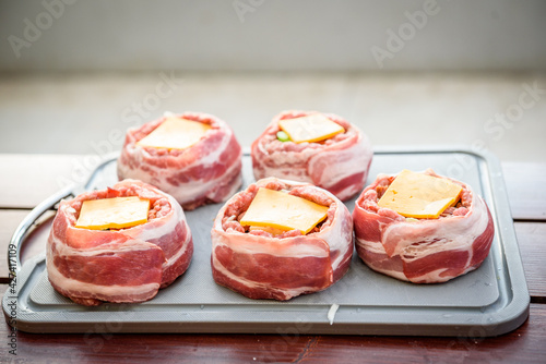 Making home made Beer Can Bacon Burgers on barbecue grill.