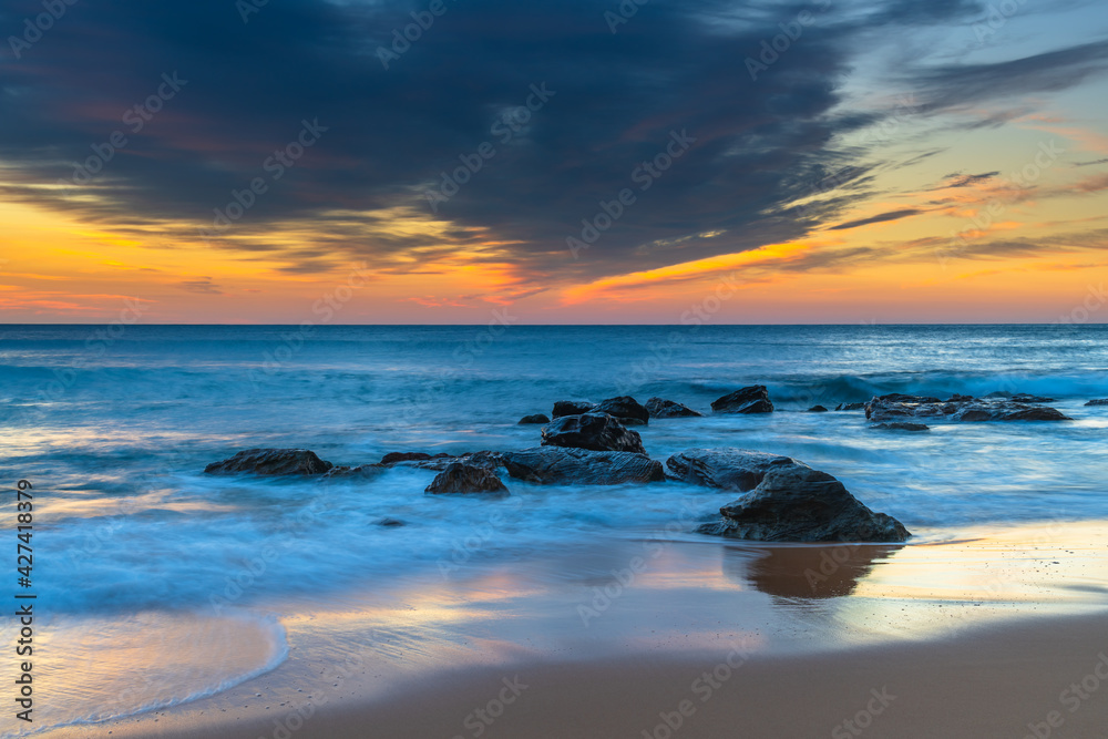 Sunrise at the beach with high cloud