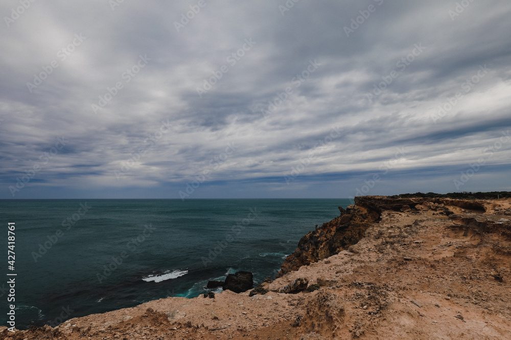 Beautiful ocean view over rocky cliffs on overcast day at Cape Nelson, Portland Victoria Australia Beautiful ocean view over rocky cliffs on overcast day at Cape Nelson, Portland Victoria Australia