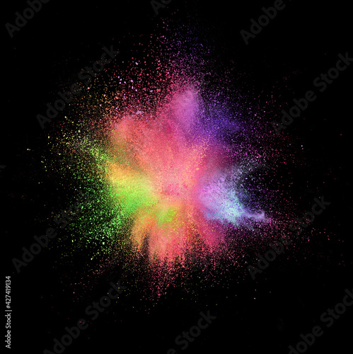 Fototapeta Naklejka Na Ścianę i Meble -  Explosion of colored, fluid and neoned powder on black studio background with copyspace