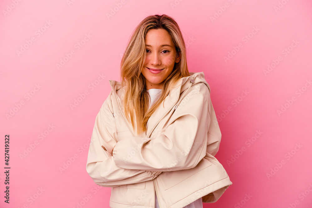 Young mixed race woman isolated on pink background who feels confident, crossing arms with determination. Young mixed race woman isolated on pink background who feels confident, crossing arms with determination.