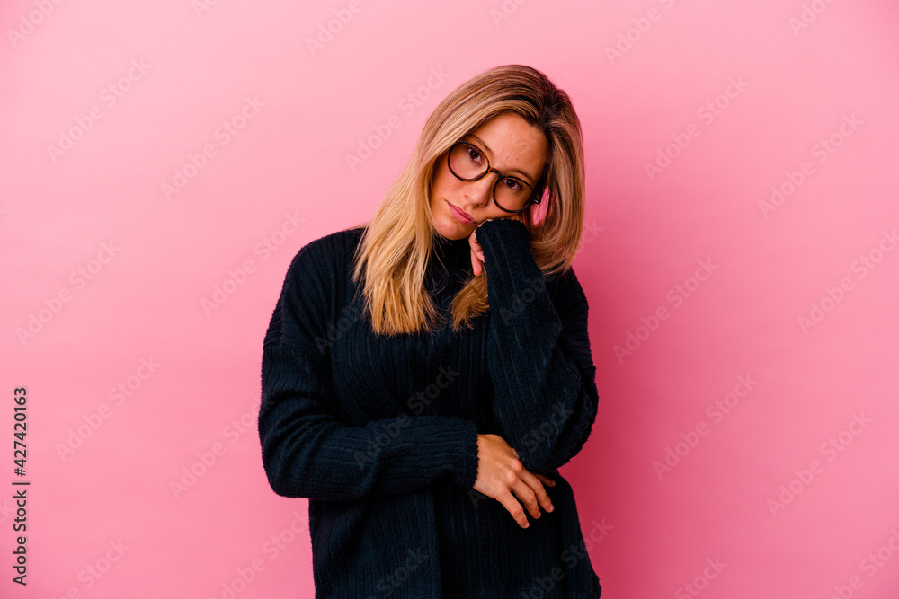 Young mixed race woman isolated on pink background tired of a repetitive task. Young mixed race woman isolated on pink background tired of a repetitive task.