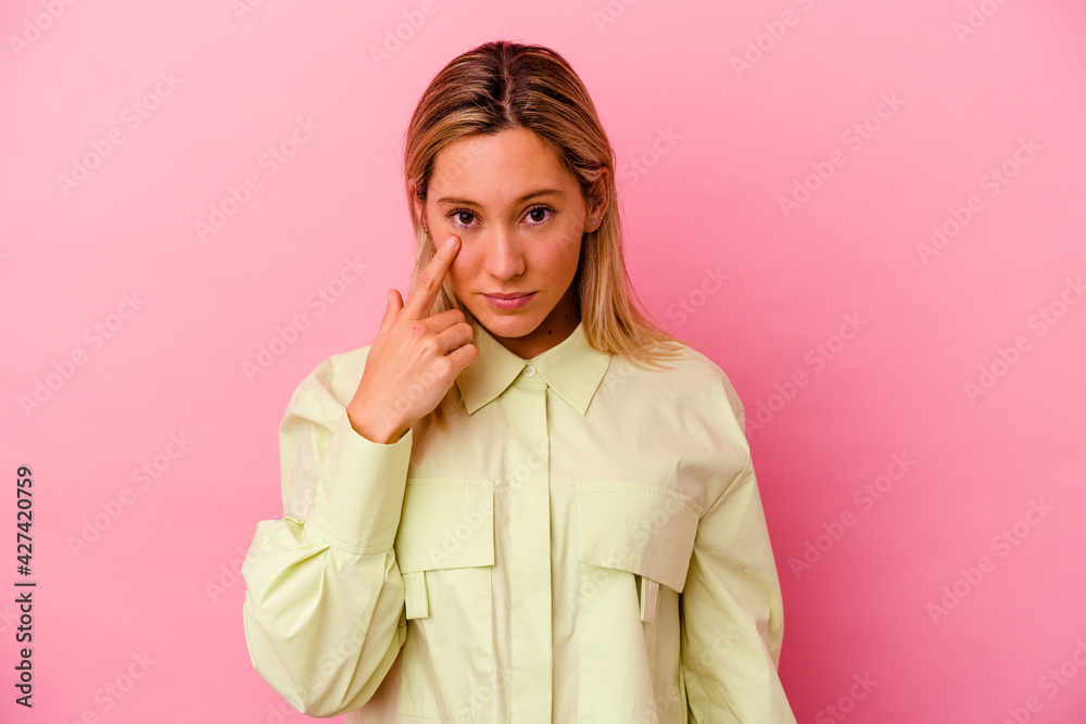 Young mixed race woman isolated on pink background crying, unhappy with something, agony and confusion concept. Young mixed race woman isolated on pink background crying, unhappy with something, agony and confusion concept.