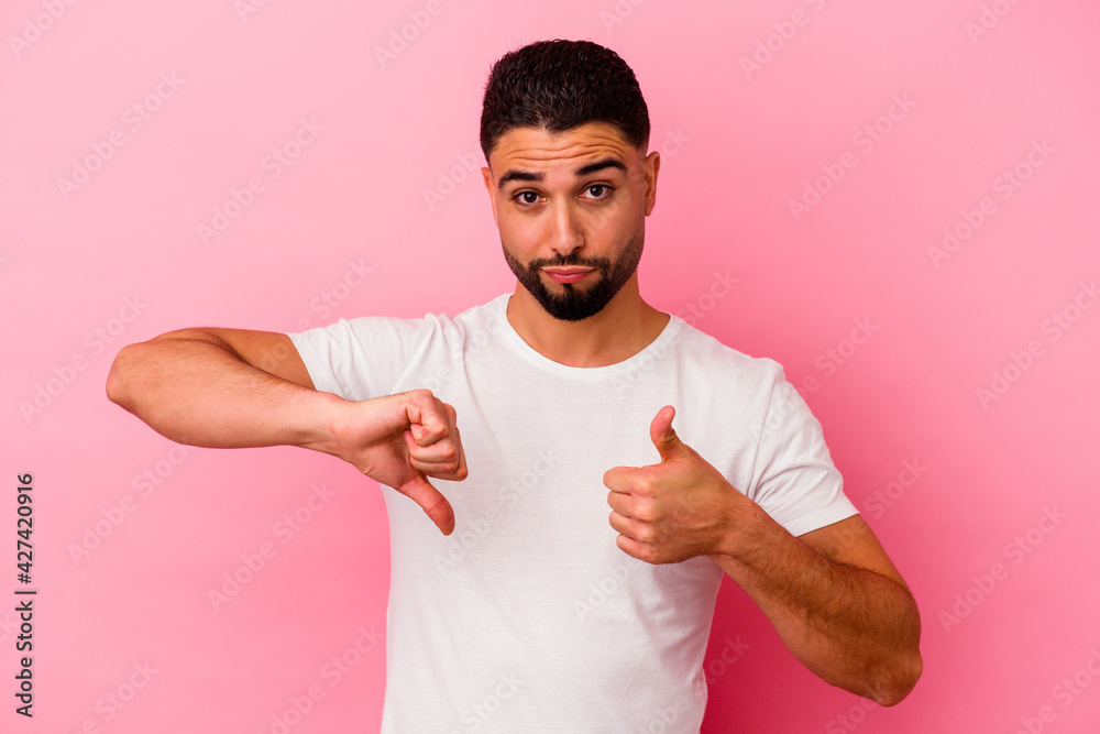Young mixed race man isolated on pink background Young mixed race man isolated on pink background