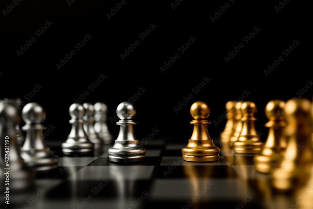 Golden and silver Chess pawn pieces Invite face to face and There are chess pieces in the background. Concept of competing, leadership and business vision for a win in business games Golden and silver Chess pawn pieces Invite face to face and There are chess pieces in the background. Concept of competing, leadership and business vision for a win in business games