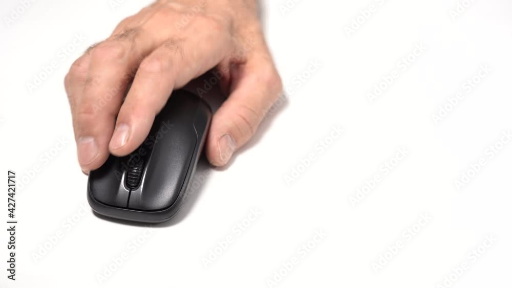 Isolated on a White Background. An Old Man's Hand Holds a Wireless Computer Mouse on the table. Click and move Isolated on a White Background. An Old Man's Hand Holds a Wireless Computer Mouse on the table. Click and move