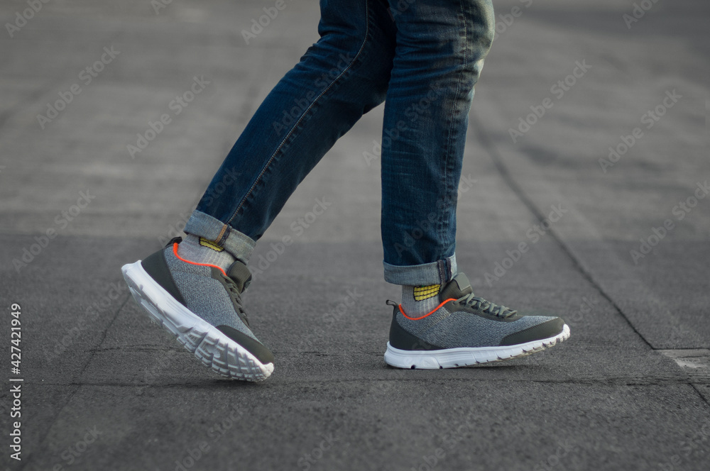 Gray sneakers on a city background Gray sneakers on a city background