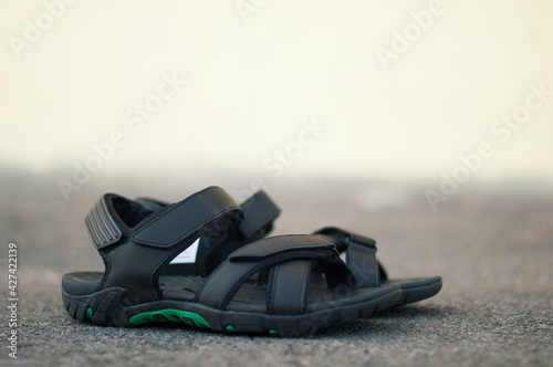 Black mens sandals on a background in the city