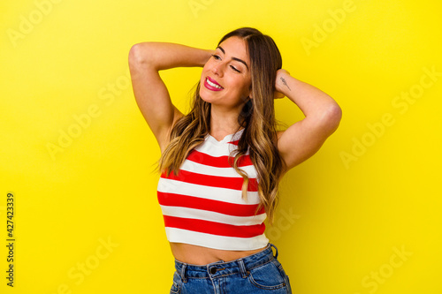 Young caucasian woman isolated on yellow background