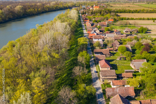 Sava river and old traditional village of Krapje with typical wooden houses, Lonjsko polje, Croatia, aerial view photo