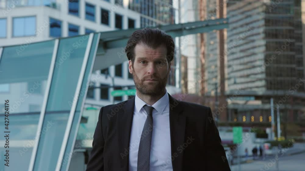 Professional businessman in a suit staring confidently at the camera, abstract business concept, slow motion. 4K 24FPS. Professional businessman in a suit staring confidently at the camera, abstract business concept, slow motion. 4K 24FPS.