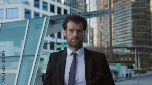 Wallpaper Mural Professional businessman in a suit staring confidently at the camera, abstract business concept, slow motion. 4K 24FPS. Torontodigital.ca