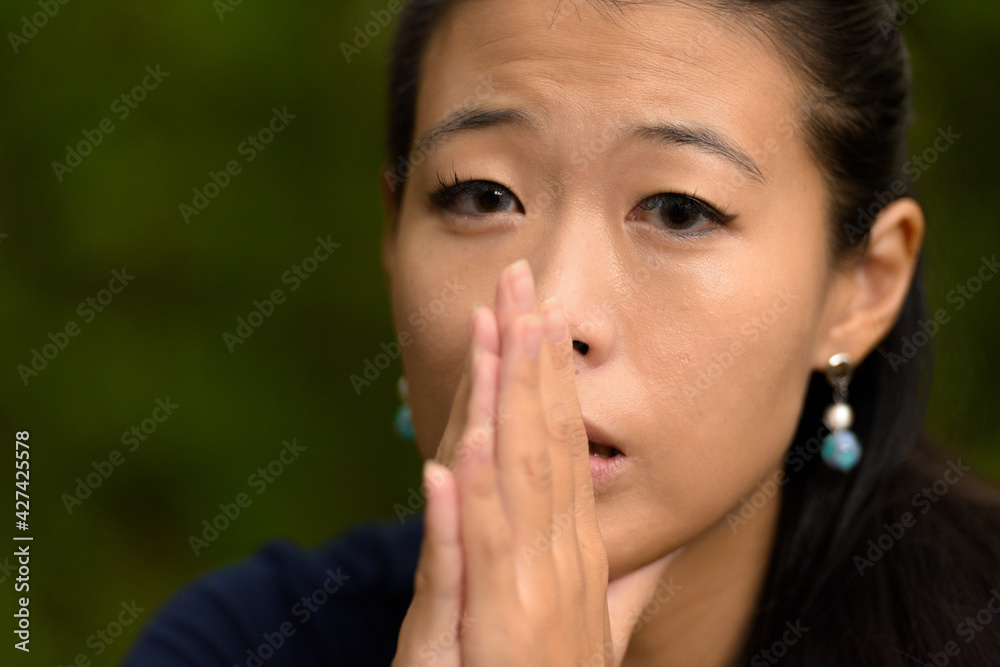 Close-up portrait of beautiful rebel Asian woman face looking stressed outdoors Close-up portrait of beautiful rebel Asian woman face looking stressed outdoors