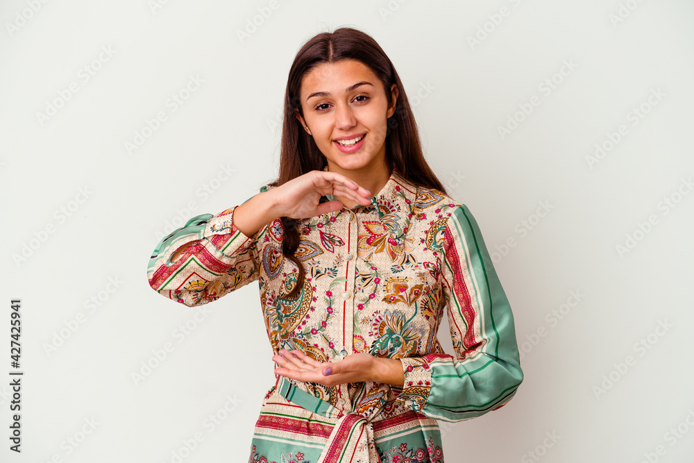 Young Indian woman isolated on white background holding something with both hands, product presentation. Young Indian woman isolated on white background holding something with both hands, product presentation.