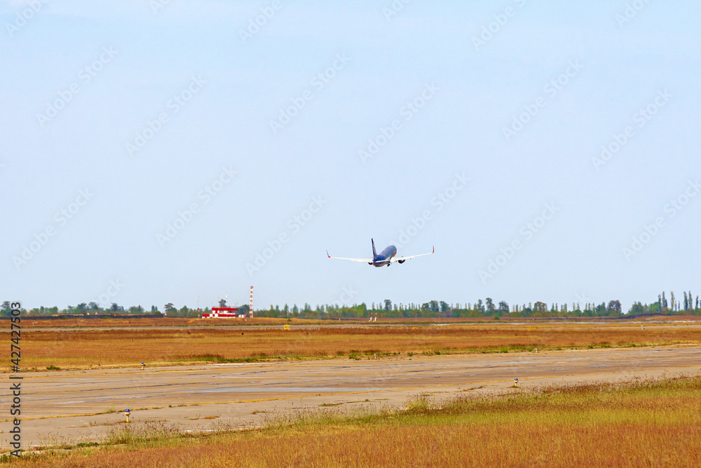 Passenger plane takes off from runway in airport Passenger plane takes off from runway in airport