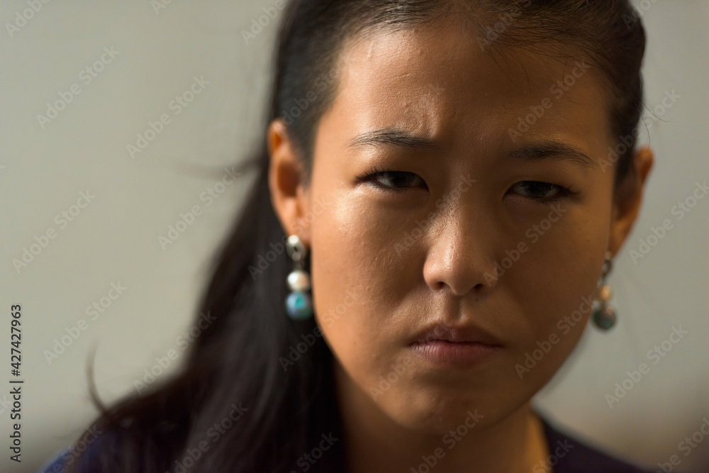 Close-up portrait of beautiful rebel Asian woman face outdoors Close-up portrait of beautiful rebel Asian woman face outdoors