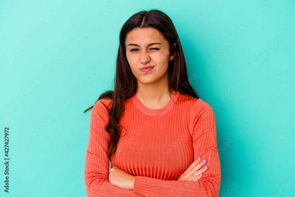 Young Indian woman isolated on blue background unhappy looking in camera with sarcastic expression.