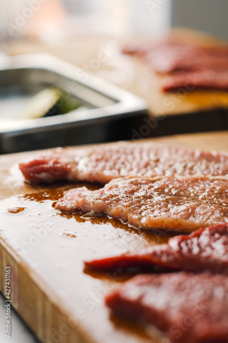 Raw fresh meat Ribeye steak entrecote pork and beef and seasonings on wooden cutting board.