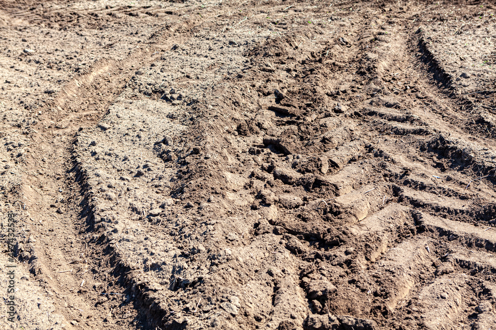Tractor track on soil . Agricultural ground background Tractor track on soil . Agricultural ground background