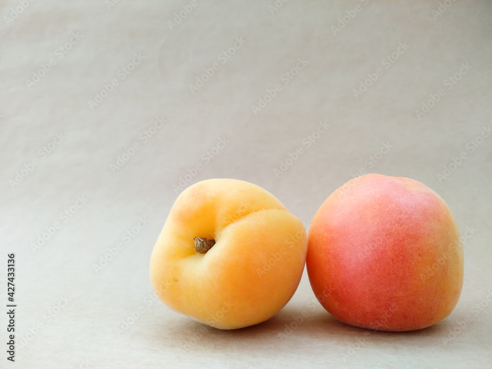 Close up apricots on beige background with copy space. Texture of yellow, orange, red ripe apricot fruits. Summer berries and fruits. Seasonal harvest. Close up apricots on beige background with copy space. Texture of yellow, orange, red ripe apricot fruits. Summer berries and fruits. Seasonal harvest.