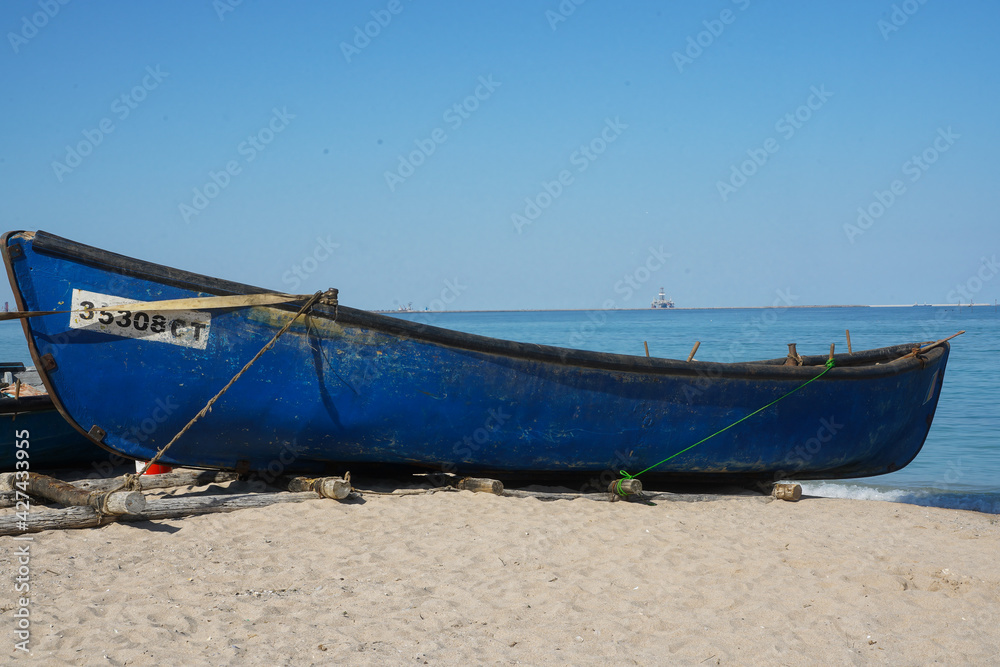 the boat of some fishermen after they brought ashore the catch. photo during the day. the boat of some fishermen after they brought ashore the catch. photo during the day.