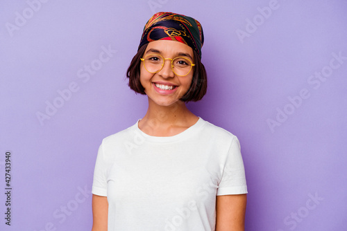 Young mixed race woman wearing a bandana isolated on purple background happy, smiling and cheerful.