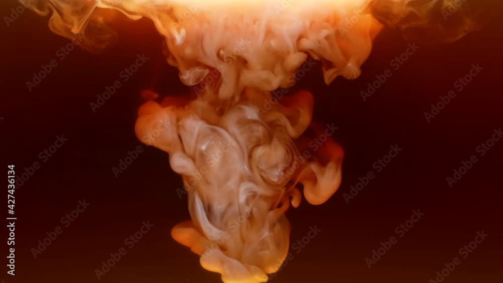 Adding milk or cream to coffee in slow motion. The milk cream settles to the bottom forming beautiful vortices in the drink. The process of making a delicious invigorating drink close up.