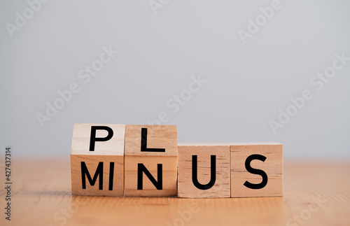 Flipping of minus to plus which print screen on wooden cube block ,Positive and negative thinking and mindset concept.