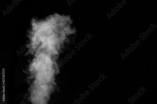 White smoke on black background. Figured smoke on a dark background. Abstract background, design element.