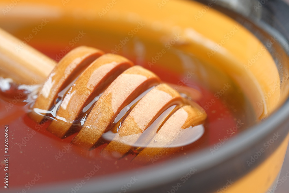 close up of fresh honey with spoon on table close up of fresh honey with spoon on table